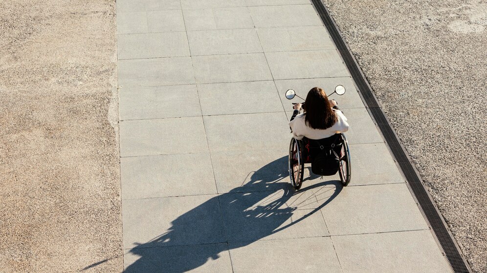 high-angle-woman-wheelchair-street_23-2148833133